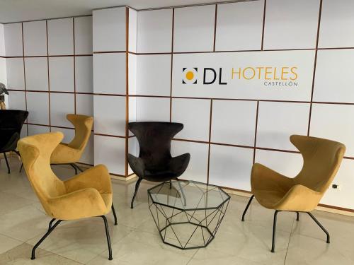 a group of chairs sitting in a room at Doña Lola in Castellón de la Plana