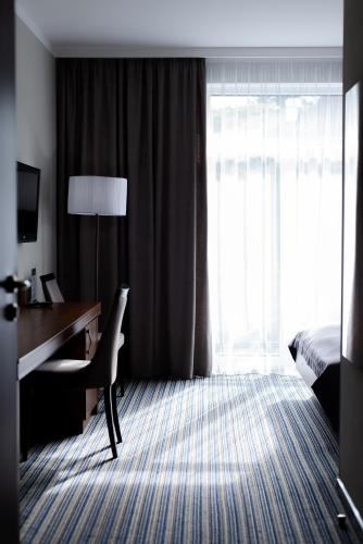 a hotel room with a desk and a bed at Hotel 4x4 in Rivne