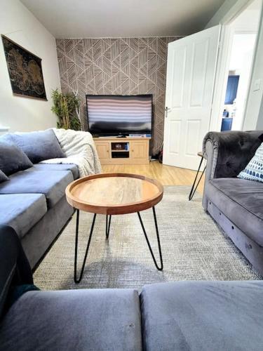 a living room with a couch and a coffee table at Modern Home2Home - Easy Centre Access & Free Parking in Sheffield