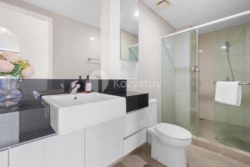 a white bathroom with a sink and a toilet at Mandala by Kozystay - Paskal in Bandung