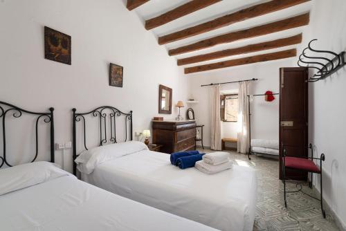 a bedroom with two beds and a dresser in it at San Sole in Vilafranca de Bonany