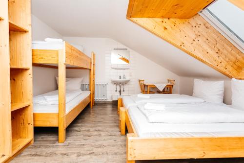 two bunk beds in a room with a table at Naturfreundehaus Brend in Neuweg