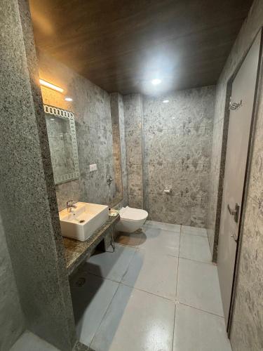 a bathroom with a sink and a toilet at Hotel M R Paradise in Jaisalmer