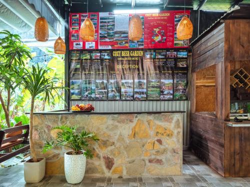 a fast food restaurant with a counter and plants at Cozy Beer Garden Homestay in Ninh Binh