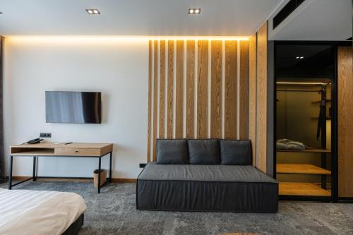 a bedroom with a bed and a desk and a table at Apartel Skhidnytsya in Skhidnitsa