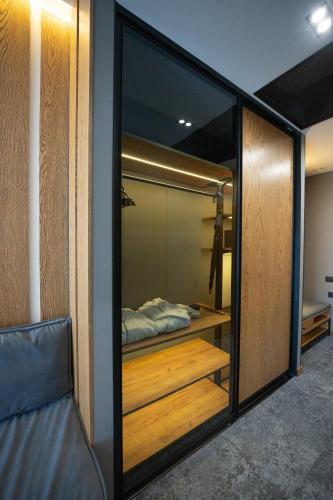 a bedroom with a sliding glass door with a bed in it at Apartel Skhidnytsya in Skhidnitsa