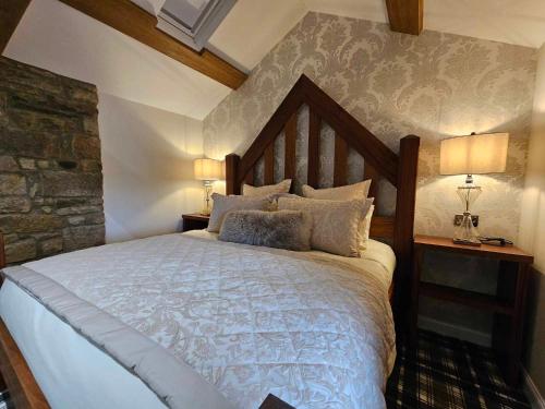 a bedroom with a large bed and two lamps at The Manor in Bishop Auckland
