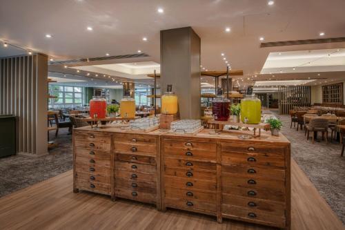 a restaurant with a counter with candles on it at De Vere Beaumont Estate in Windsor