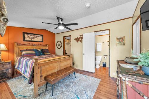 a bedroom with a bed with an orange wall at Wild Horses Suite 1 by The Lodges at Fossil Creek in Shay