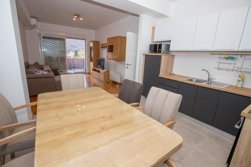 a kitchen and dining room with a wooden table and chairs at Luxury Apartments Valentino in Ohrid