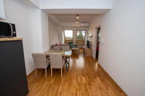 a kitchen and living room with a table and chairs at Luxury Apartments Valentino in Ohrid