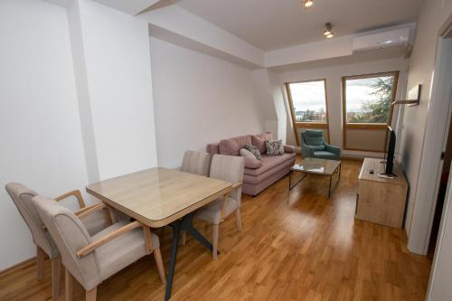 a living room with a table and a couch at Luxury Apartments Valentino in Ohrid