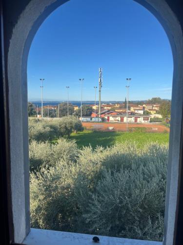 an arched window with a view of a field at Apartments Colombara Bardolino in Bardolino
