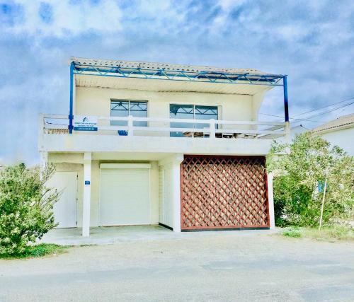 a house with a balcony on top of it at Chalet Alaric & Jacuzzi Ilot 1 rang1! VUE MER! 4rooms! CLIM 10p 24H24 in Gruissan