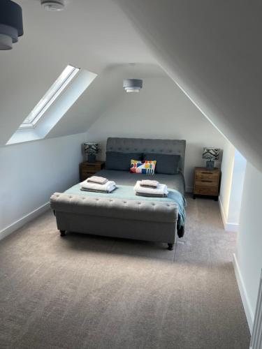a bedroom with a bed in a attic at The Snug at Fourleys in Woodhurst