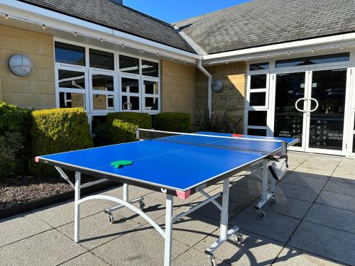 a ping pong table in front of a house at De Vere Beaumont Estate in Windsor