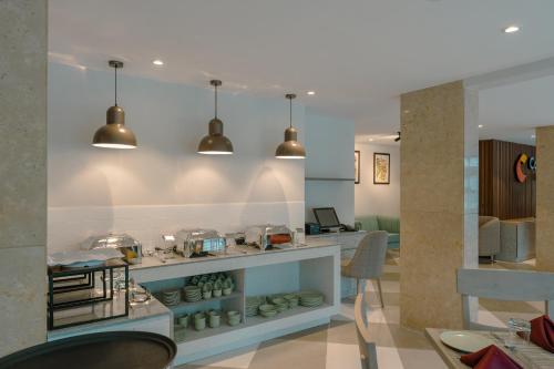 a kitchen with two pendant lights above a counter at Comfort Inn Elite in Jua