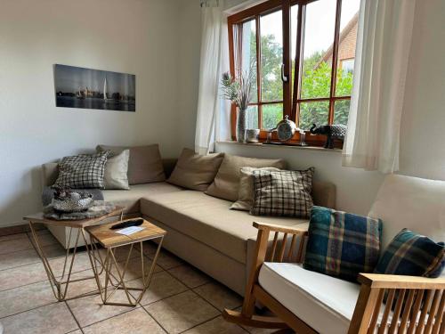 a living room with a couch and a table at Ferienwohnung Störblick Schwerin in Raben Steinfeld