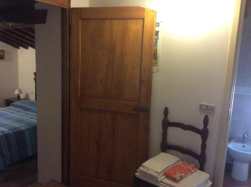 a bathroom with a door and a chair in a room at Agriturismo Podere Fiume in Pratovecchio