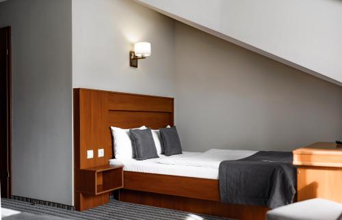 a bedroom with a bed and a stair case at Hotel 4x4 in Rivne