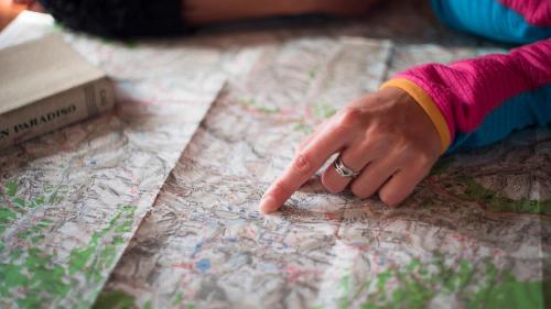 a hand with a ring pointing at a map at Agriturismo Plan de la Tour B&B in Cogne