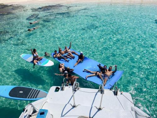 a group of people on a boat in the water at Casa Verde Hotel - Steps to the Beach, Pool, Restaurant & Bar in Rincon