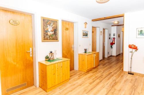 a hallway with wooden doors and wooden floors at Naturfreundehaus Brend in Neuweg