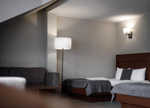 a hotel room with a bed and a chair at Hotel 4x4 in Rivne