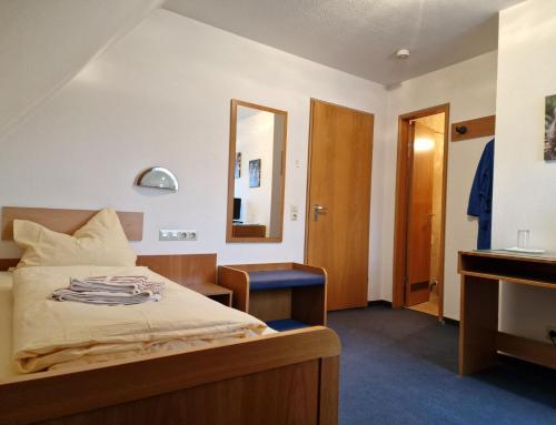 a bedroom with a bed with a mirror and a sink at Gästehaus Schniepp in Stuttgart