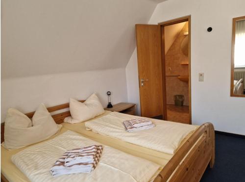 a bedroom with two beds with towels on them at Gästehaus Schniepp in Stuttgart