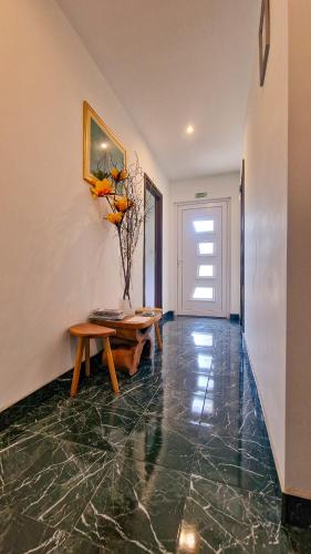 a living room with a table and a bench at Rooms Sunny valley in Krupa