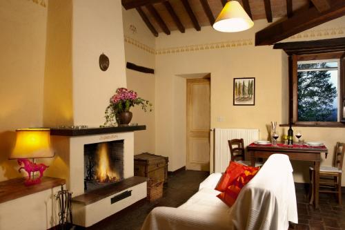 a living room with a fireplace and a table at Villa Illuminata by MMega in Calzolaro
