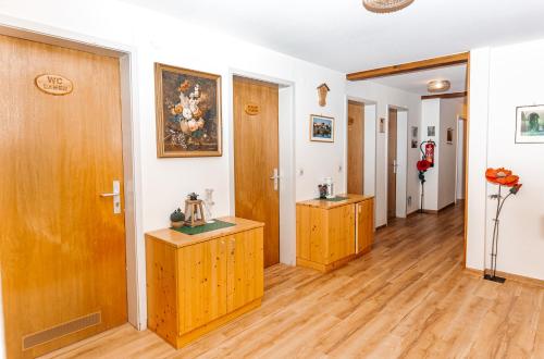 a hallway with wooden doors and wooden floors at Naturfreundehaus Brend in Neuweg