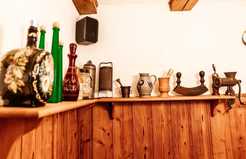 a wooden shelf with bottles and other items on it at Naturfreundehaus Brend in Neuweg