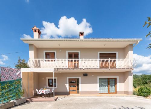 a large house with a balcony on top of it at Apartman Nona in Motovun