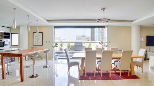 a kitchen and dining room with a table and chairs at 4 on Pritchard Luxury Suites in Johannesburg