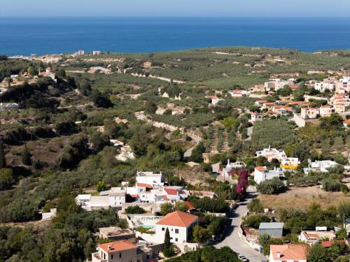 an aerial view of a small village with the ocean at The Artemis Home, pure rustic romance, By ThinkVilla in Astérion