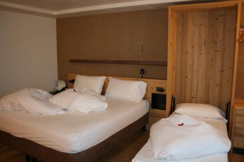 Ένα ή περισσότερα κρεβάτια σε δωμάτιο στο Hotel Orso Grigio