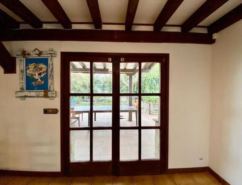 a room with a door and a patio with a table at Kite Holiday House Tarifa in Tarifa