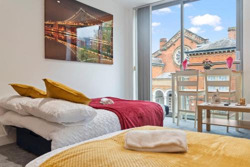 a room with two beds and a large window at Heart of City Centre Luxury Apartment with Secure Underground Parking in Birmingham