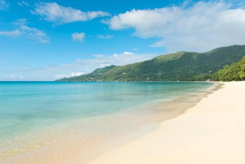 a sandy beach with a blue sky at STORY Seychelles in Beau Vallon