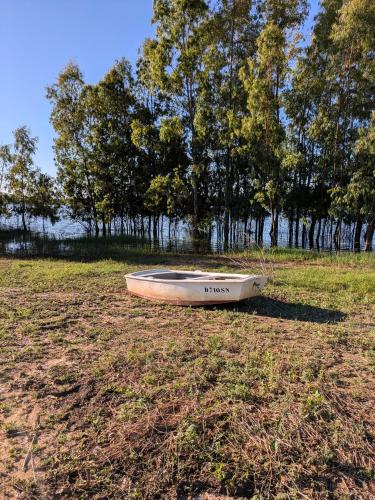 a boat sitting on the grass in a field at Casas de Juromenha in Juromenha