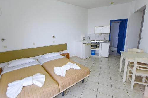 a bedroom with a bed with bows on it at Amalia Sea Hotel in Rhodes Town