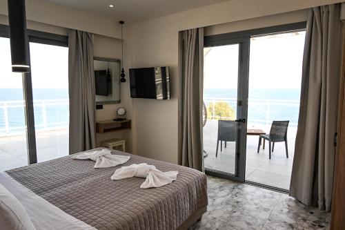 a bedroom with a bed and a view of the ocean at Amalia Sea Hotel in Rhodes Town