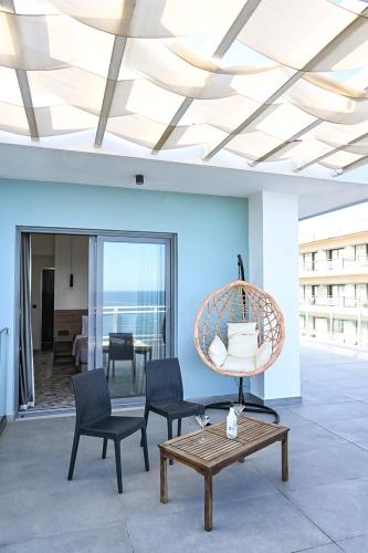 a living room with two chairs and a table at Amalia Sea Hotel in Rhodes Town