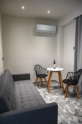 a living room with a couch and a table at Amalia Sea Hotel in Rhodes Town