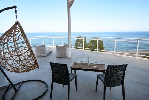 a patio with a table and chairs and the ocean at Amalia Sea Hotel in Rhodes Town