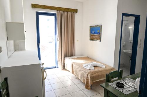 a small room with a bed and a bathroom at Amalia Sea Hotel in Rhodes Town