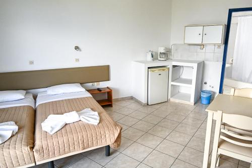 a small room with two beds and a kitchen at Amalia Sea Hotel in Rhodes Town