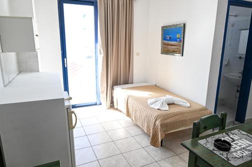 a small room with a bed and a bathroom at Amalia Sea Hotel in Rhodes Town